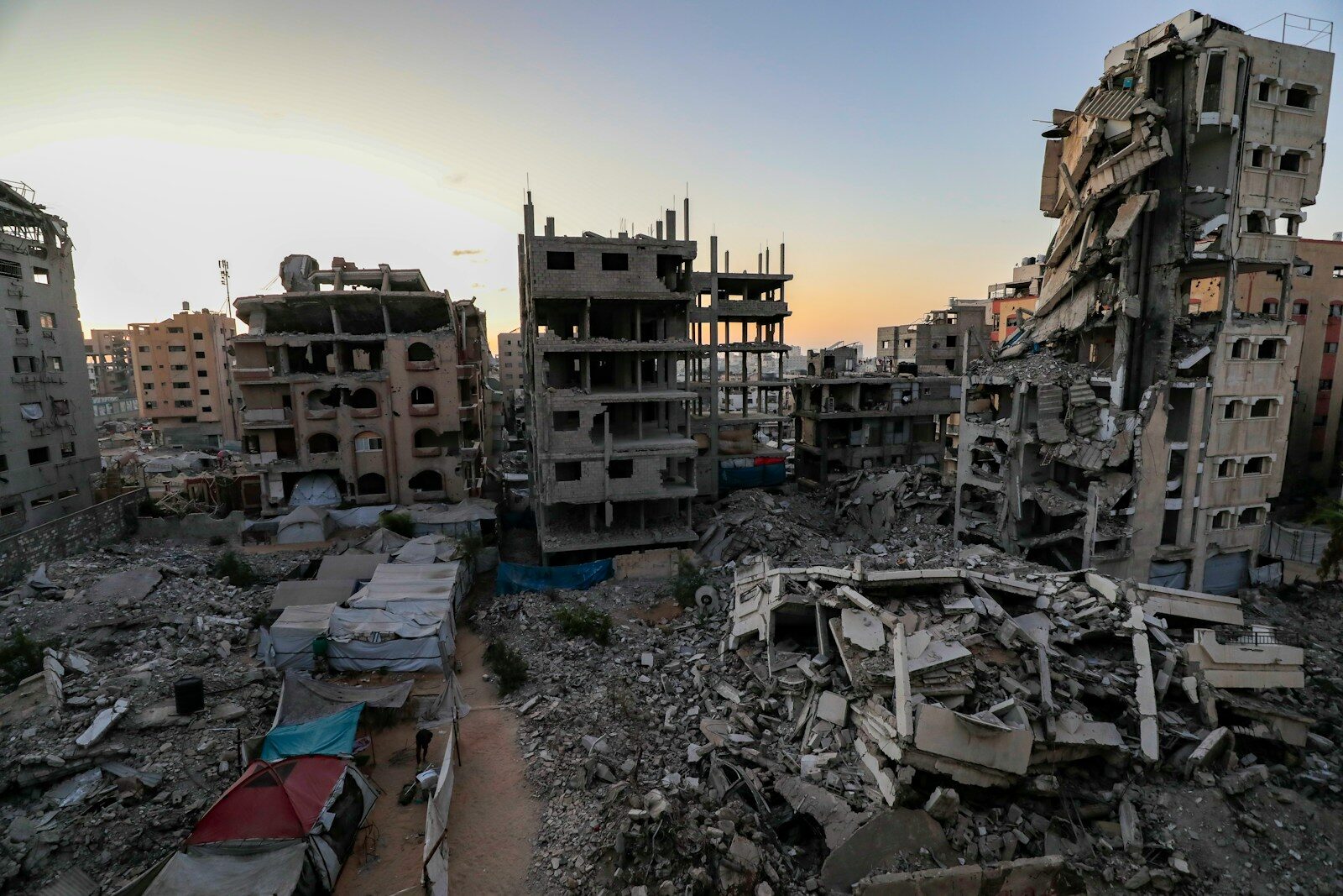 Photo by Mohammed Ibrahim Damaged buildings and rubble in a city